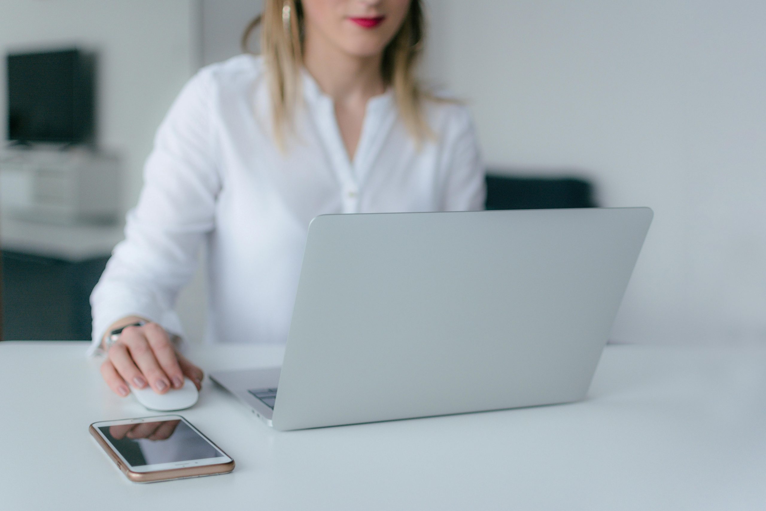 professionally dressed woman using a laptop